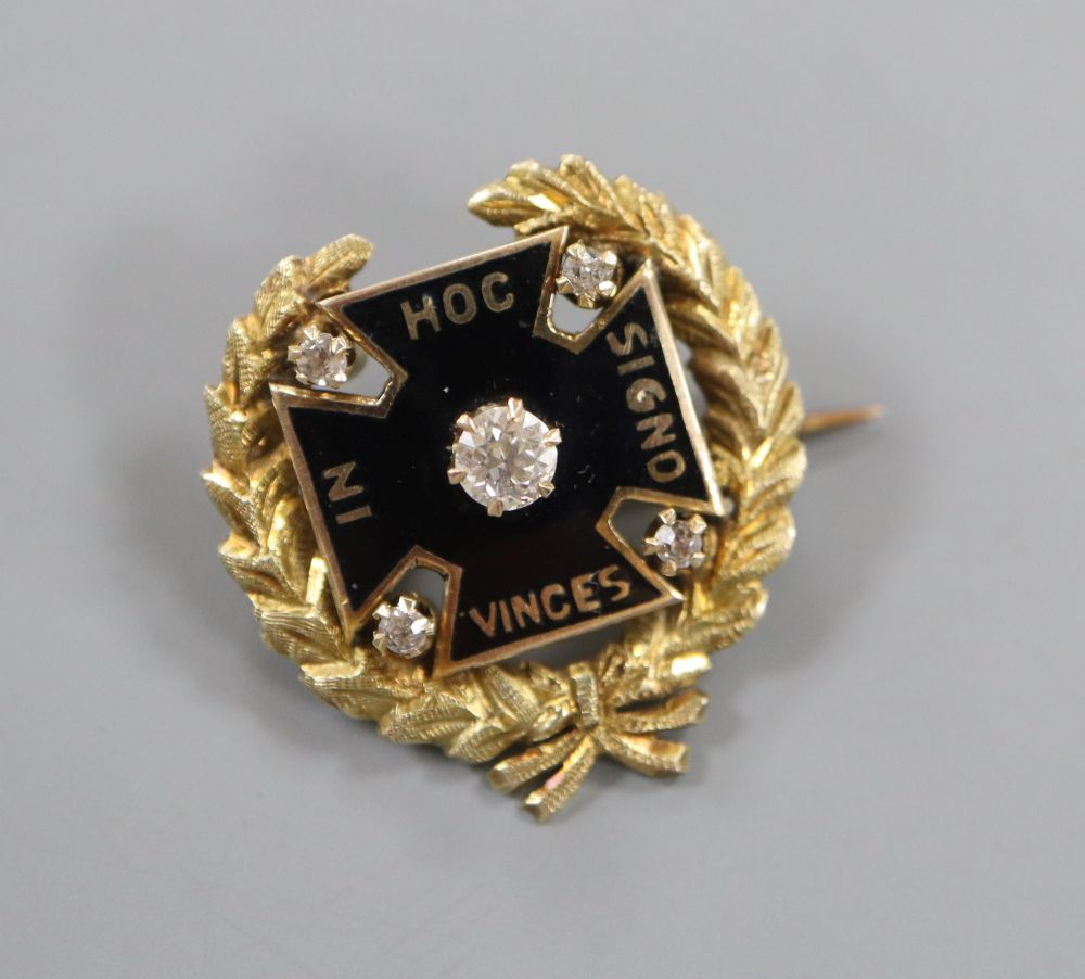 An early 20th century yellow metal, black enamel and diamond set brooch